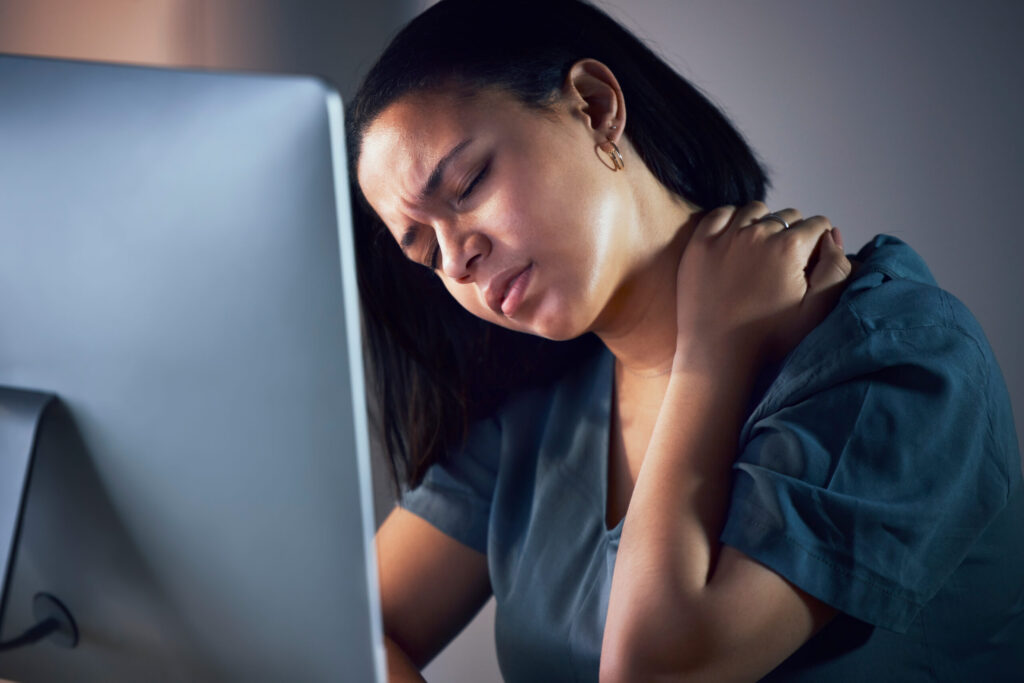 Woman holding the back of her neck experiencing stress and tension